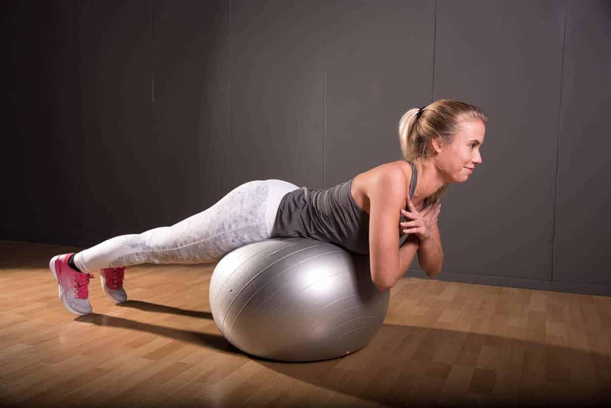Back Extension on stability ball, arms crossed